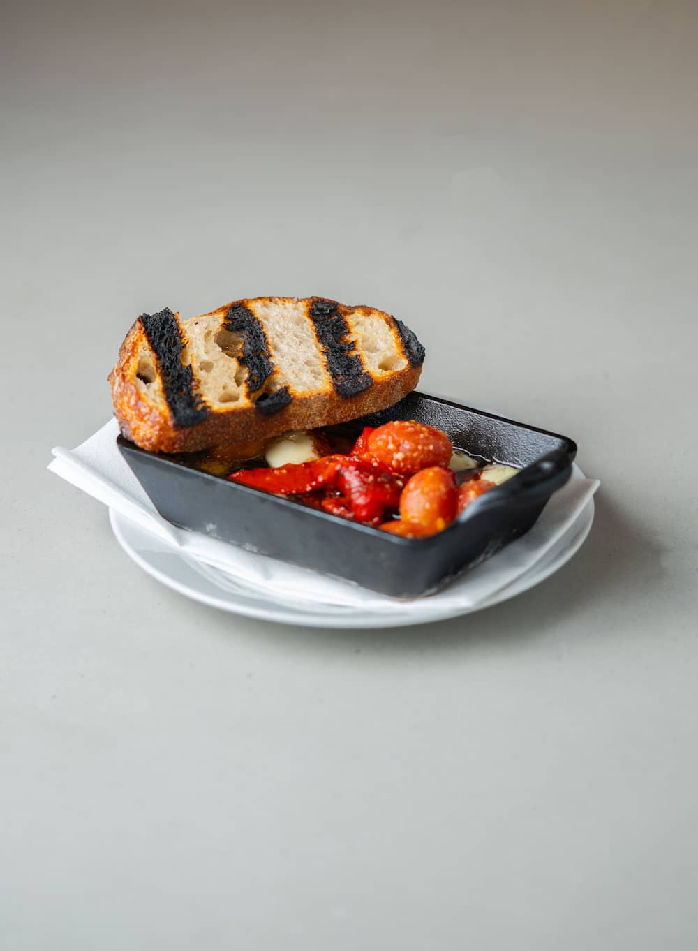 Cherry tomatoes and grilled bread done right.